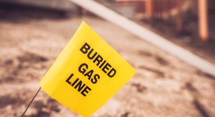 Yellow buried gas line flag in a construction site